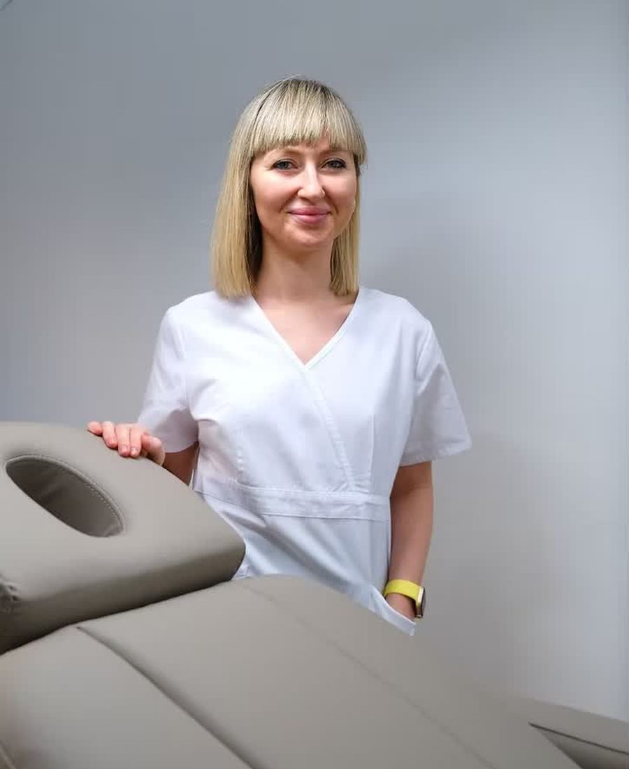 The practitioner standing beside the treatment chair at Honey Lips.